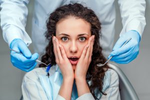 patient scared at the dentist - dental anxiety