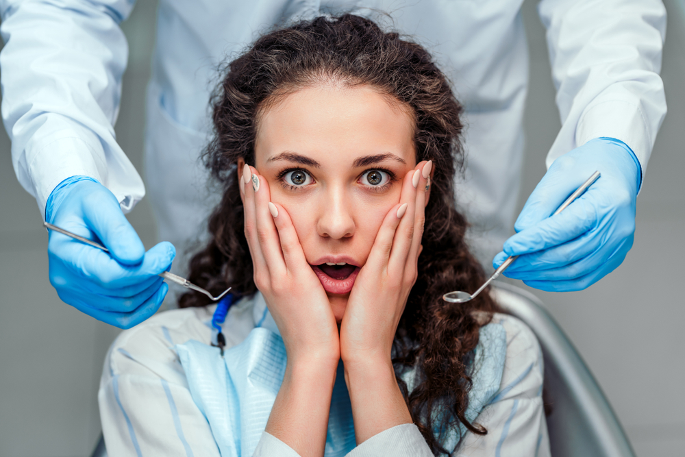 patient scared at the dentist - dental anxiety