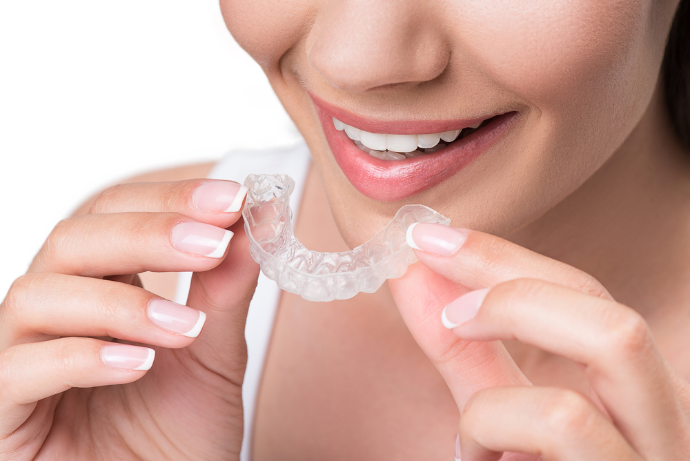 woman putting in her Invisalign trays