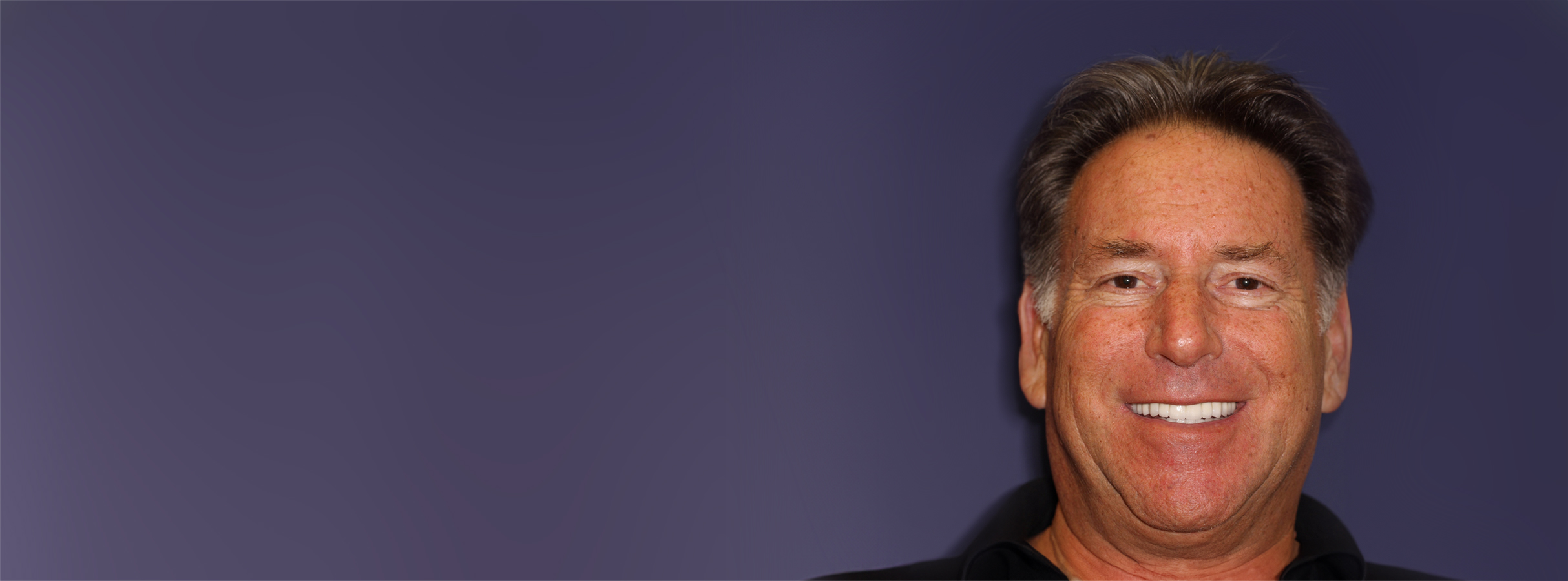 Smiling man with a full mouth reconstruction, showcasing restored dental health and confidence, related to PGA Dentistry's treatment success story.